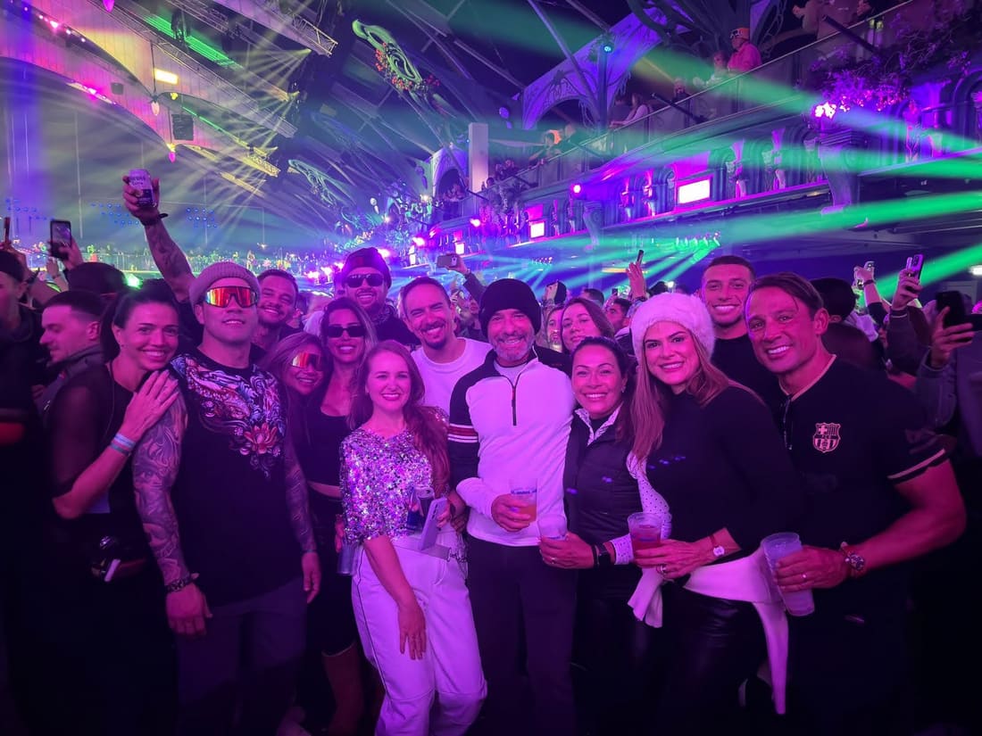 Grupo da Never Ends no meio do público da Tomorrowland Winter, com os lasers roxos e verdes do Mainstage coberto